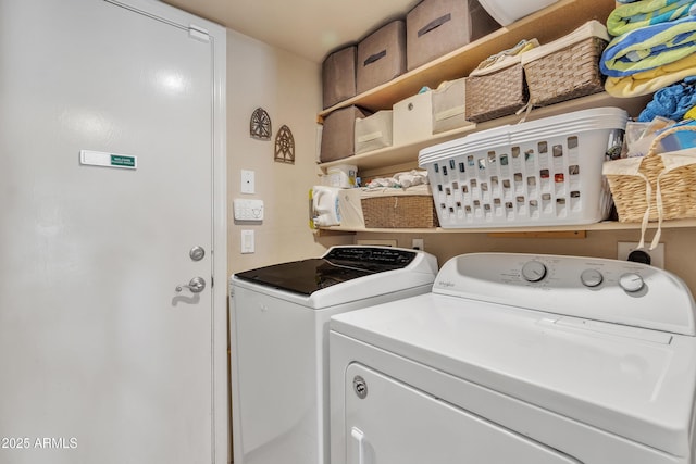 clothes washing area featuring washer and dryer and laundry area