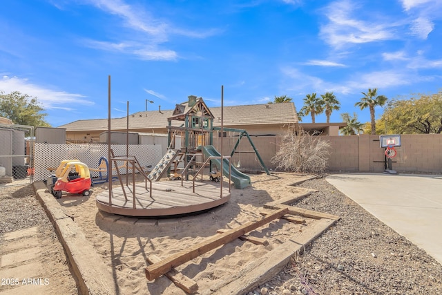 exterior space with a playground and fence