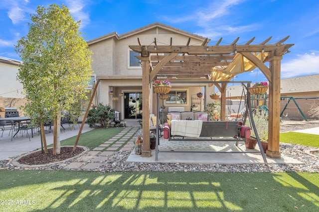 rear view of property with a patio, fence, a yard, a pergola, and stucco siding