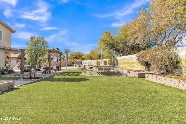 view of yard featuring a patio area, a fenced backyard, a trampoline, and a pergola