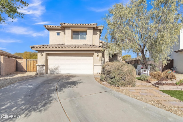 view of front of house featuring a garage, driveway, a tile roof, fence, and stucco siding