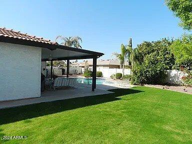 view of yard featuring a fenced in pool and a patio area