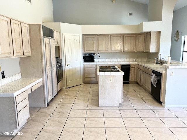 kitchen with tile countertops, high vaulted ceiling, a kitchen island, a sink, and black appliances