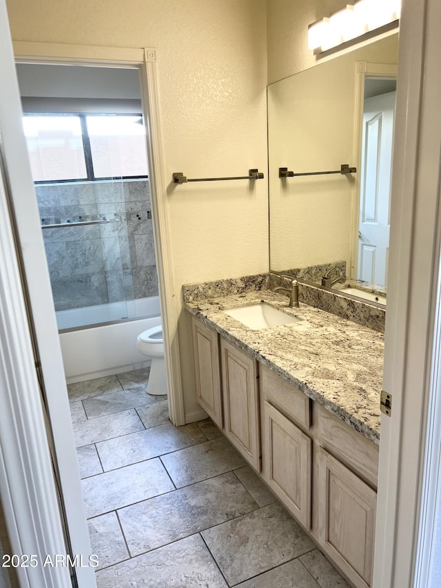 bathroom featuring combined bath / shower with glass door, toilet, and vanity