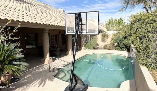 view of swimming pool featuring a fenced in pool and a patio