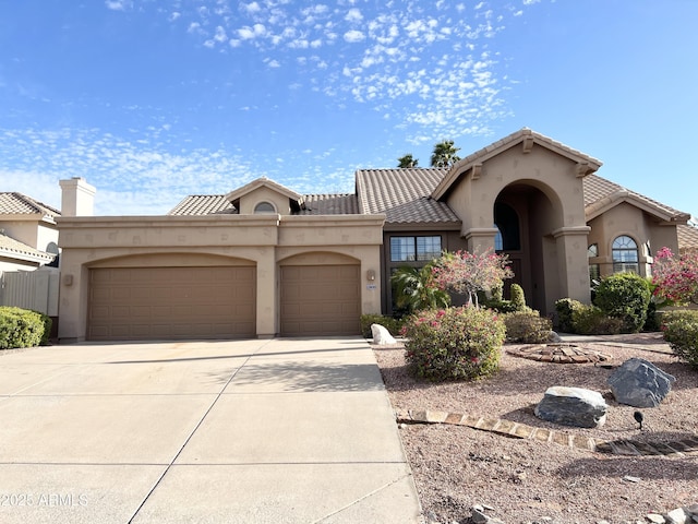 mediterranean / spanish-style home with concrete driveway, a tiled roof, a garage, and stucco siding