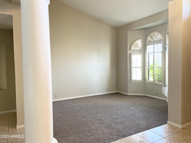 unfurnished room with tile patterned floors, baseboards, and carpet