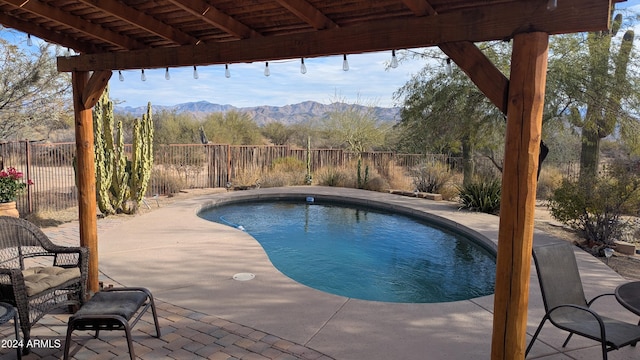 view of swimming pool featuring a mountain view and a patio area