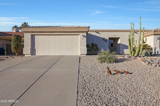 ranch-style home featuring a garage, concrete driveway, and stucco siding