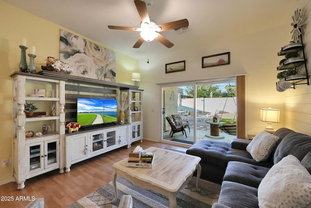 living area featuring ceiling fan, wood finished floors, visible vents, and baseboards