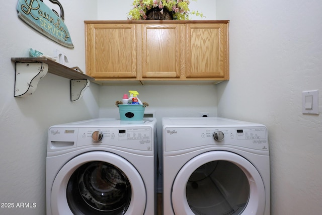 washroom with cabinet space and washing machine and clothes dryer