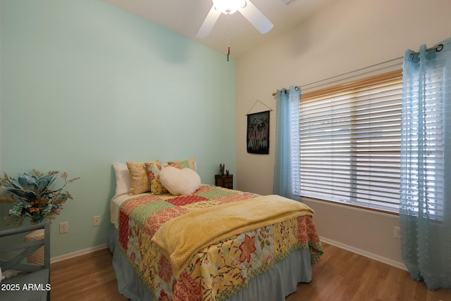 bedroom featuring ceiling fan, wood finished floors, and baseboards