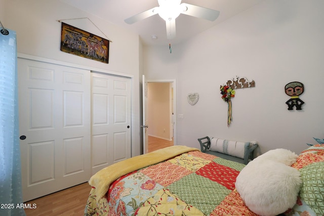 bedroom featuring ceiling fan, a closet, and wood finished floors