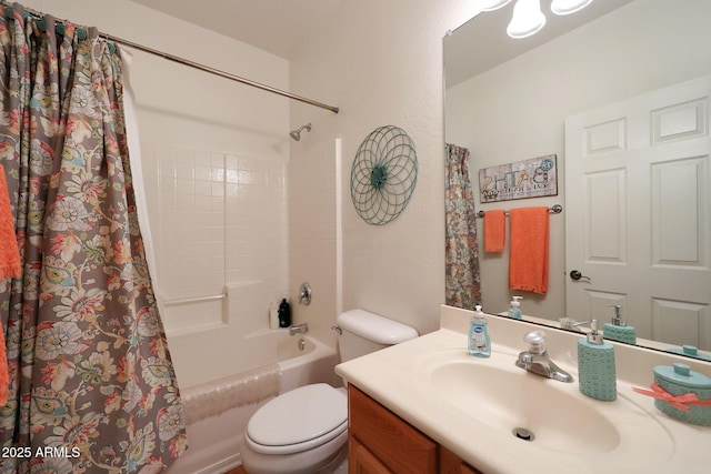 bathroom featuring toilet, shower / bath combo with shower curtain, and vanity