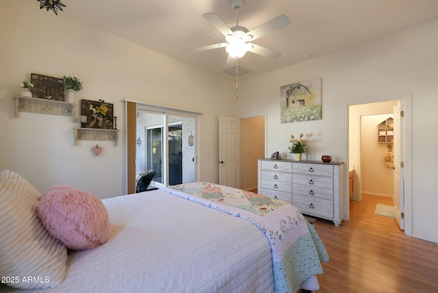 bedroom with access to exterior, a ceiling fan, visible vents, and wood finished floors