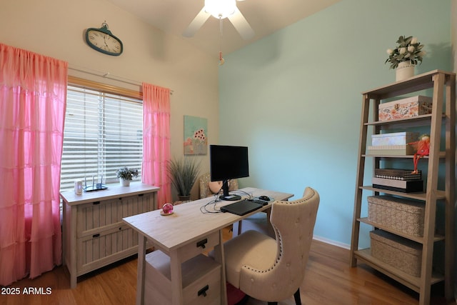 office area featuring a ceiling fan, baseboards, and light wood finished floors