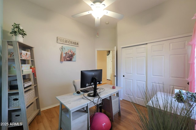 office with baseboards, a ceiling fan, and wood finished floors