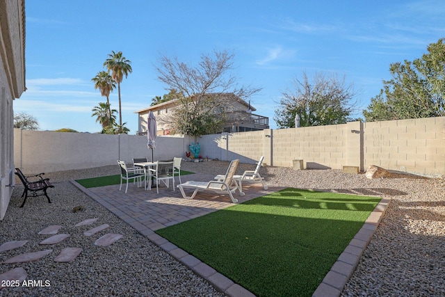 view of yard with a fenced backyard and a patio