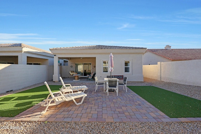 back of house with a patio area, a fenced backyard, and stucco siding