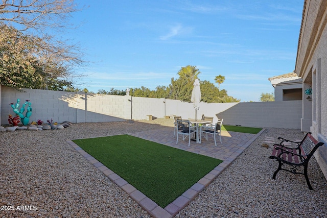 view of yard with a patio area and a fenced backyard