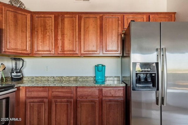 920 E Devonshire Ave Unit 2031, Phoenix, AZ 85014 - kitchen featuring appliances with stainless steel finishes, brown cabinetry, and light countertops