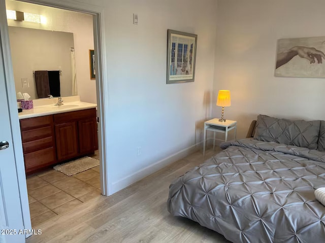 920 E Devonshire Ave Unit 2031, Phoenix, AZ 85014 - bedroom featuring light wood-style flooring and connected bathroom