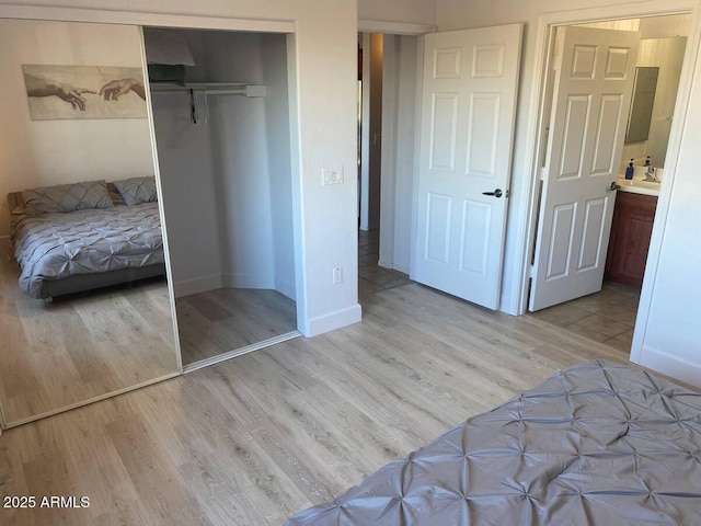 920 E Devonshire Ave Unit 2031, Phoenix, AZ 85014 - bedroom featuring light wood finished floors and a closet