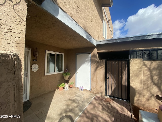 doorway to property with a patio