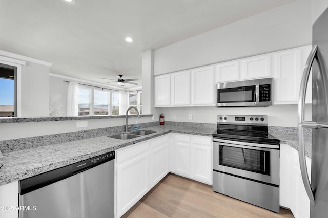 20100 N 78th Pl Unit 3103, Scottsdale, AZ 85255 - kitchen with appliances with stainless steel finishes, a sink, a ceiling fan, white cabinets, and recessed lighting