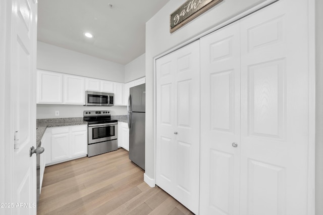 20100 N 78th Pl Unit 3103, Scottsdale, AZ 85255 - kitchen featuring stainless steel appliances, white cabinetry, light stone counters, light wood-style flooring, and recessed lighting