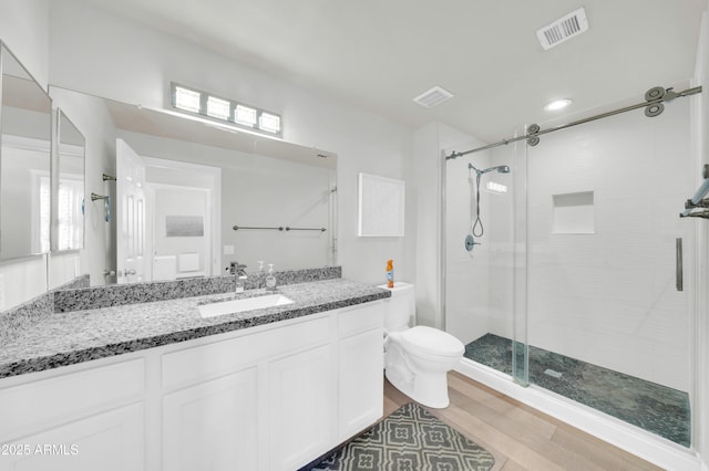 20100 N 78th Pl Unit 3103, Scottsdale, AZ 85255 - full bath with a stall shower, toilet, vanity, and wood finished floors