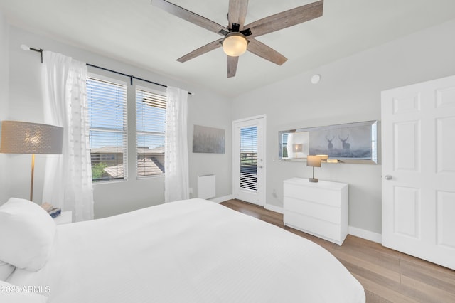 20100 N 78th Pl Unit 3103, Scottsdale, AZ 85255 - bedroom featuring baseboards, wood finished floors, access to exterior, and a ceiling fan