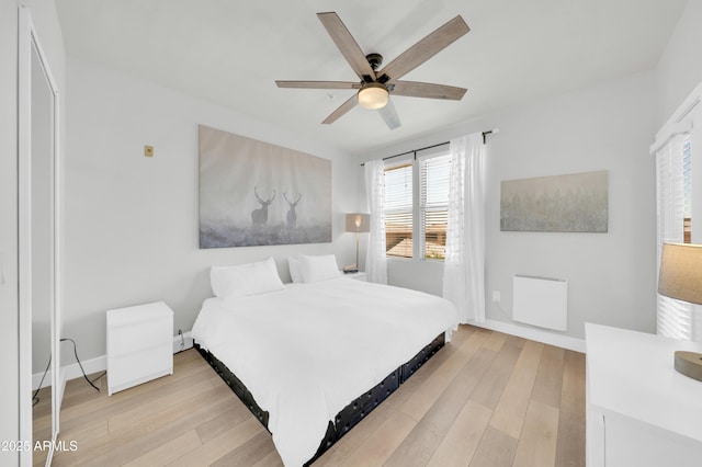 20100 N 78th Pl Unit 3103, Scottsdale, AZ 85255 - bedroom featuring radiator heating unit, light wood-type flooring, baseboards, and a ceiling fan
