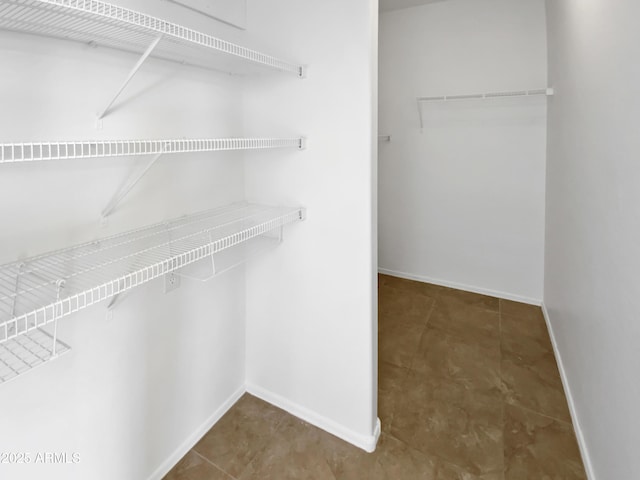 walk in closet featuring tile patterned flooring