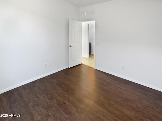 empty room featuring dark hardwood / wood-style floors