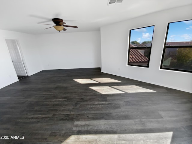 empty room featuring ceiling fan and dark wood-type flooring