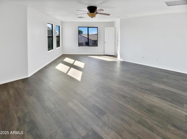 empty room with ceiling fan and dark wood-type flooring