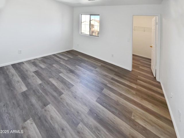 unfurnished room featuring dark wood-type flooring