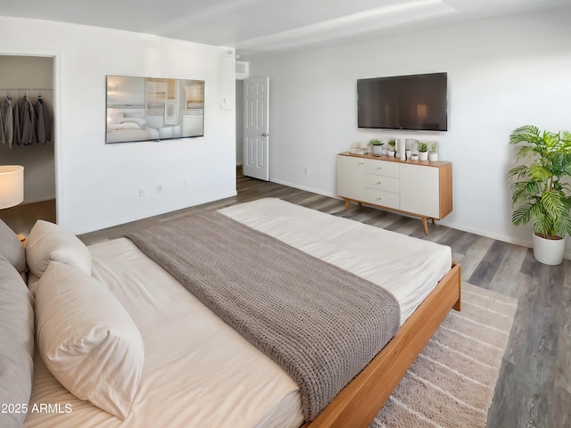 bedroom with a closet and dark hardwood / wood-style floors