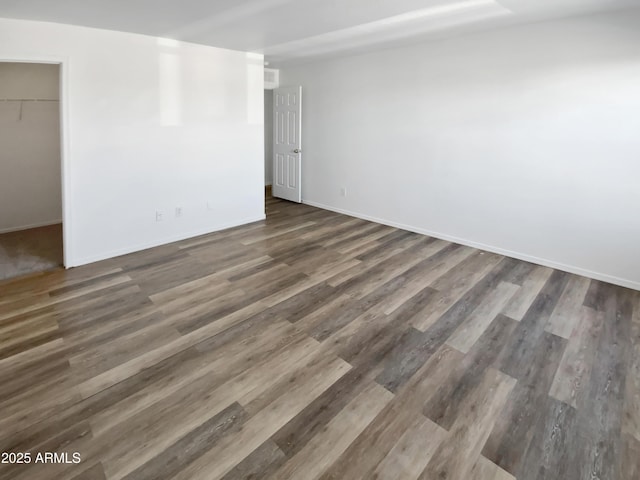 spare room featuring dark wood-type flooring