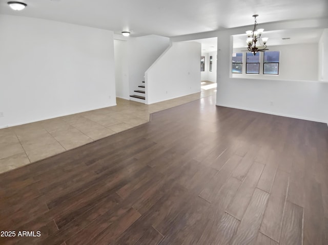 unfurnished living room featuring light hardwood / wood-style floors and an inviting chandelier