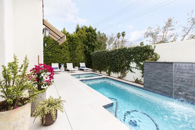 view of swimming pool featuring an in-ground hot tub and a fenced backyard