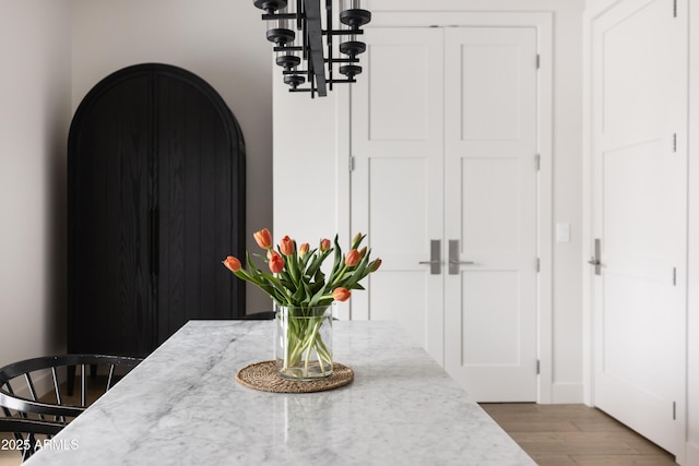 detailed view of a chandelier and wood finished floors