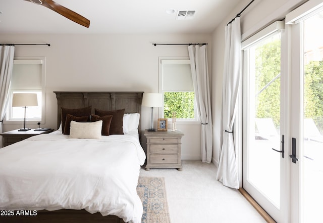 bedroom featuring access to exterior and light colored carpet