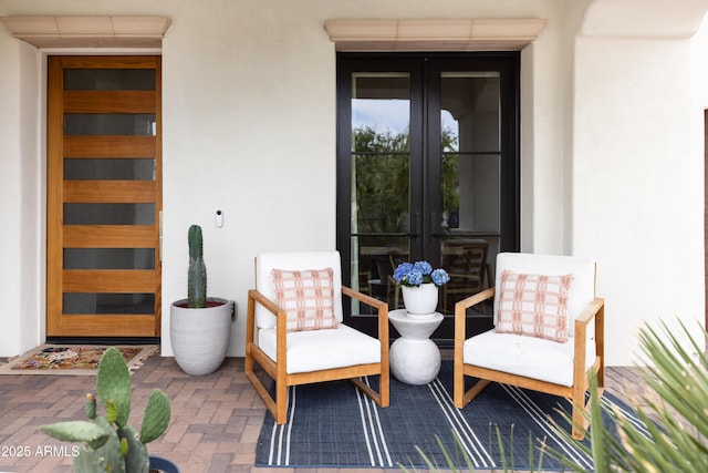 property entrance with french doors and stucco siding