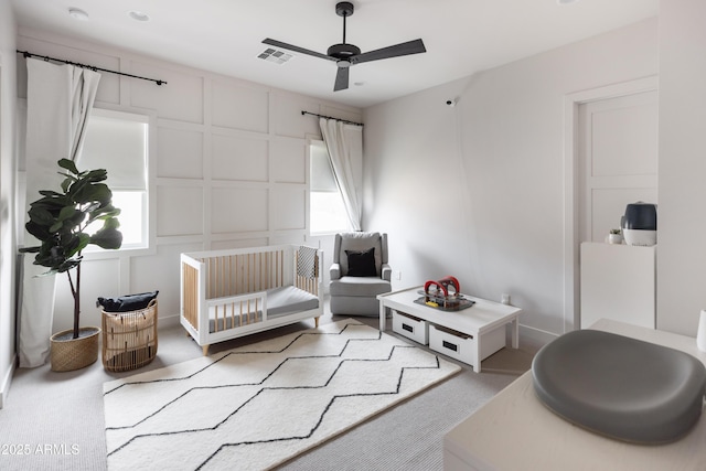 bedroom featuring a decorative wall and light carpet