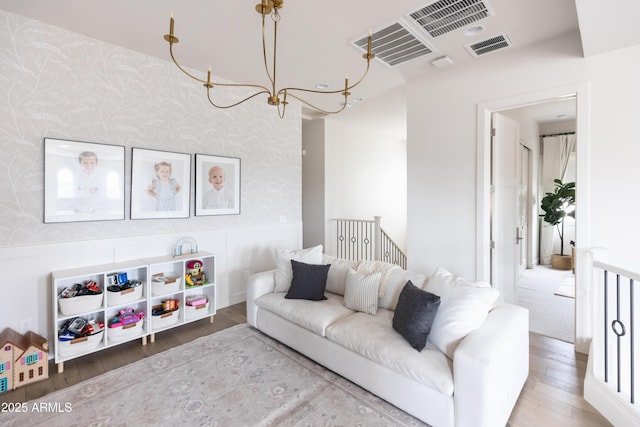 living area featuring wallpapered walls and wood finished floors