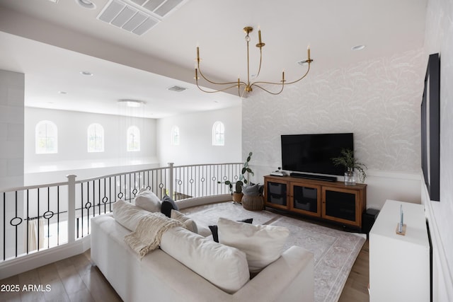 living area with wallpapered walls and wood finished floors