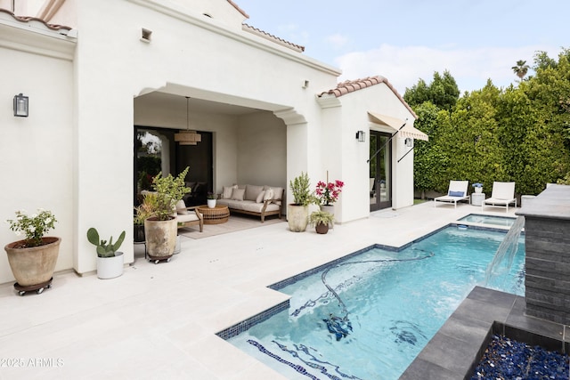 rear view of property with a patio area, stucco siding, a tiled roof, outdoor lounge area, and a pool with connected hot tub
