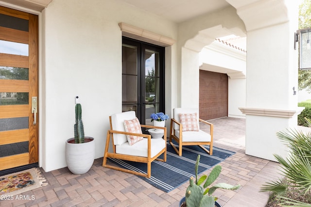 entrance to property featuring stucco siding